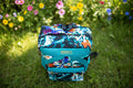Sac à dos artisanal en toile de jute turquoise et motifs abstraits multi-couleurs